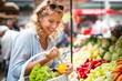 © NDABCREATIVITY - Young woman shopping healthy food on the market