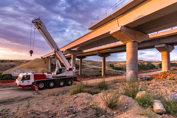 Wall Mural - Crane trucks in the construction of a bridge