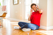 © Krakenimages.com - Beautiful young african american woman with afro hair listening to music and dancing wearing headphones