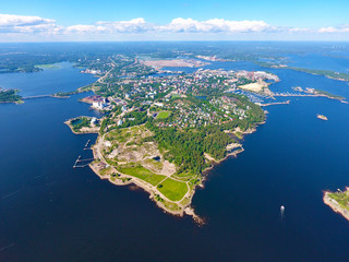 Summer aerial photography with drone. Island and sea bays, water and boat. Finland city of Kotka. Skyline