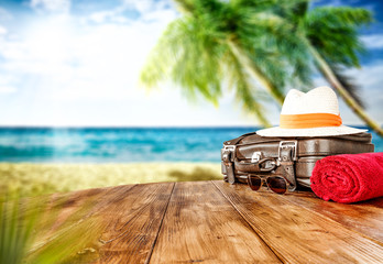 Summer retro suitcase on desk and beach landscape 