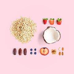 Wall Mural - Creative layout made of oatmeal, coconut, strawberry, plum, dried dates, blueberry, almond and walnut. Flat lay. Food concept.