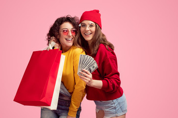 Wall Mural - cheerful hipsters with cash and paper bags