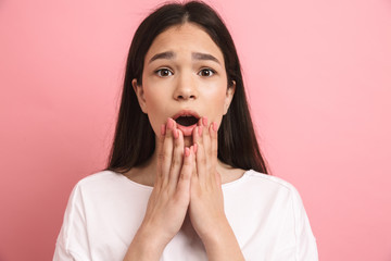 Portrait closeup of youthful surprised girl in casual wear looking at camera with open mouth