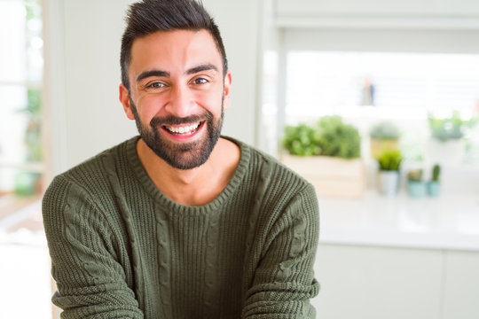 Handsome man smiling cheerful with a big smile on face showing teeth, positive and happy expression