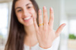 © Krakenimages.com - Beautiful young woman showing hand wearing wedding alliance ring