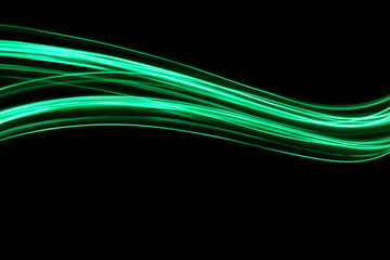 Wall Mural - Long exposure, light painting photography.  Vibrant neon green streaks of colour against a black background