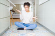 © Krakenimages.com - Beautiful young african american woman with afro hair sitting on the floor clueless and confused expression with arms and hands raised. Doubt concept.
