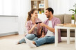 © Syda Productions - leisure, celebration and valentines day concept - happy couple drinking red wine at home