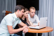 © biggur - Group of two young euphoric students watching exam results in a laptop in a table