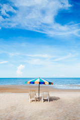 Wall Mural - Beach beds and colourful umbrella with ocean horizon view and clear sky slightly clouds in summer