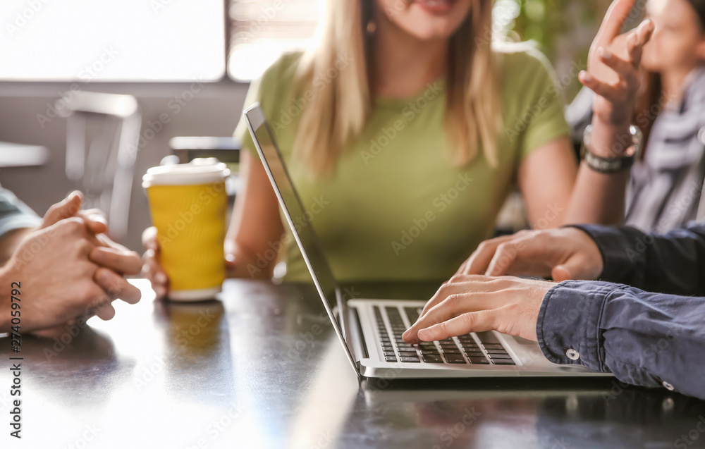 Young colleagues during coffee break in cafe