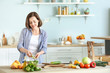 © Pixel-Shot - Young woman making salad in kitchen