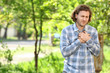 © Pixel-Shot - Young man suffering from pain in chest outdoors