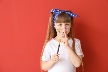 Poster - Cute little artist showing silence gesture on color background