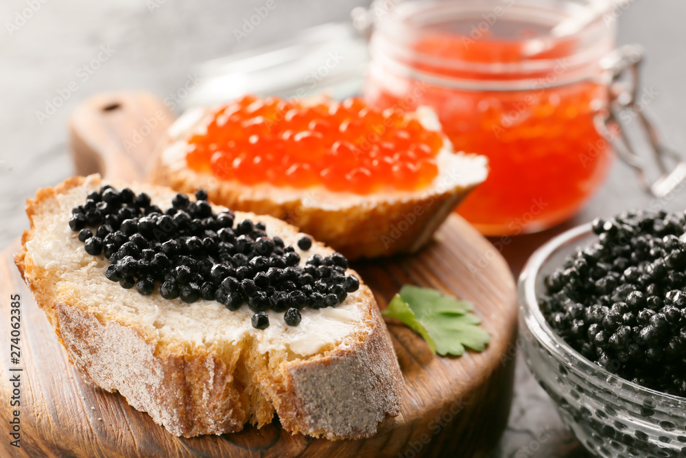 Sandwiches with delicious caviar on board, closeup - obrazy, fototapety, plakaty 