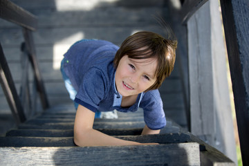 Sticker - Child, preteen boy, sitting on wooden stairs