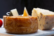 Variety of Italian pecorino cheeses, yellow aged, with black peppers from Nebrodi, white Il Palio and black molarotto, close up