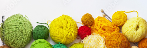 Fotografía Panoramic top view on colorful balls of yarn for hand knitting on a white background