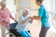 Nurse helping elderly woman in wheelchair