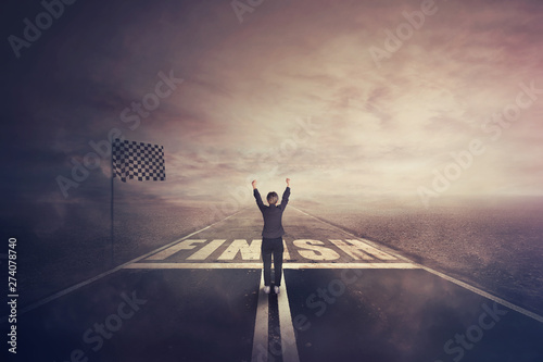 Fotomural Competitive woman, raising hands up, celebrate on the road as crossing the finish line