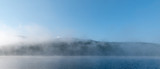 Fototapeta Na ścianę - early morning mountains lake covered in fog 