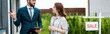 © LIGHTFIELD STUDIOS - panoramic shot of handsome bearded broker holding clipboard and gesturing near attractive woman
