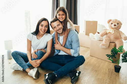 Happy family having fun while moving into new apartment фототапет