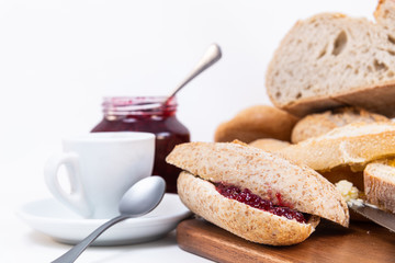 view multigrain bread, two small pieces of bread with jam. Raspberry jam and espresso coffee