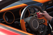 Hands Of A Man On A Steering Wheel In A Sports Car