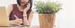 © stnazkul - Woman small business owner, business start up conceptual, young entrepreneur work with laptop receiving phone call write down notes, banner wide dimension
