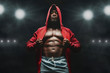 © Prostock-studio - African american fighter in hoodie at boxing ring
