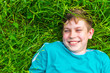 © Mariia Nazarova - happy teen boy lying in the grass in summer