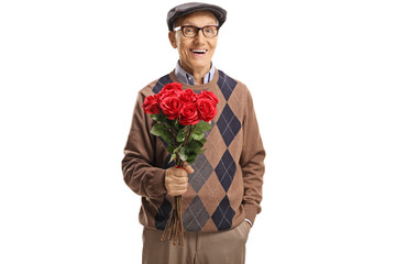 Wall Mural - Cheerful senior gentleman posing with a bouquet of red roses