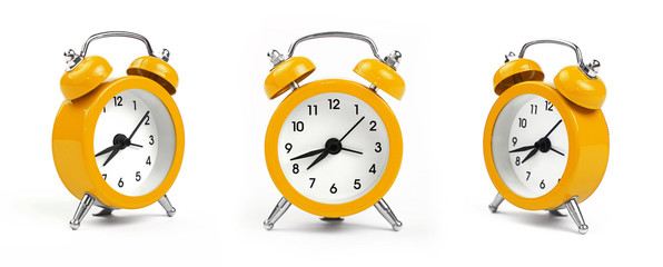 three yellow alarm clock over white