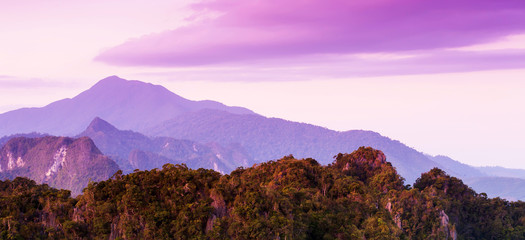 Wall Mural - Panoramic limestone mountains and dramatic clouds at dusk.