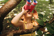 © Z A C - Closeup portrait of little girl looking through a binoculars searching for an imagination or exploration in summer day in park. Child playing with binocular pretend safari game outdoors in the forest