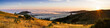 Panoramic view at sunset of valley covered in a sea of clouds in the Santa Cruz mountains, San Francisco bay area, California