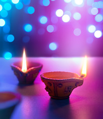 Wall Mural - Diya lamps on floor with bokeh light background