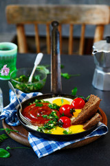 Wall Mural - Fried eggs with sausages and green salsa