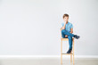 © Pixel-Shot - Stylish boy in jeans near grey wall
