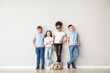 © Pixel-Shot - Stylish children in jeans near light wall