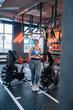 © Viacheslav Yakobchuk - Plump woman standing near exercise cycle in gym