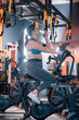 © Viacheslav Yakobchuk - Dark-haired woman wearing leggings and top cycling in gym
