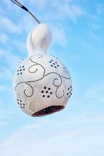 Handmade Decorative Calabash Gourd Lamp Against Blue Sky Background