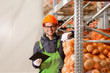 © bnenin - Portrait of a smiling young worker at organic food production warehouse.