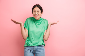 Sticker - Photo of perplexed young girl wearing round eyeglasses throwing up her hands