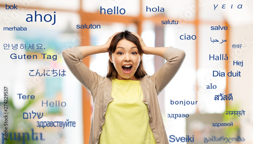 Foto translation, education and people concept - happy asian young woman holding to h