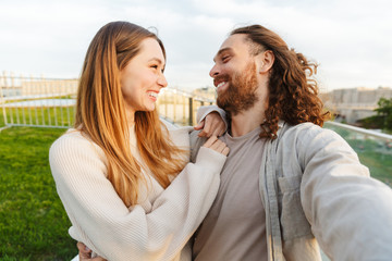 Wall Mural - Beautiful young couple in love walking outd at the park