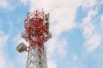 Wireless Communication Antenna Transmitter. Telecommunication tower with antennas on blue sky background.